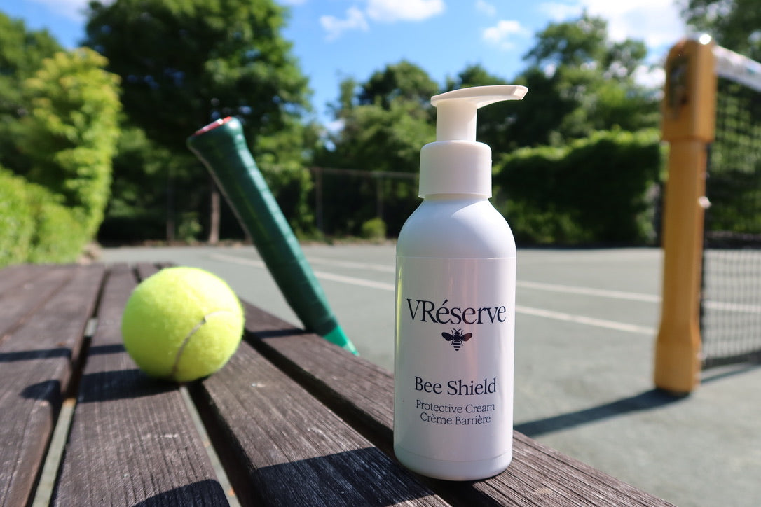 product on side of tennis court with racquet and ball