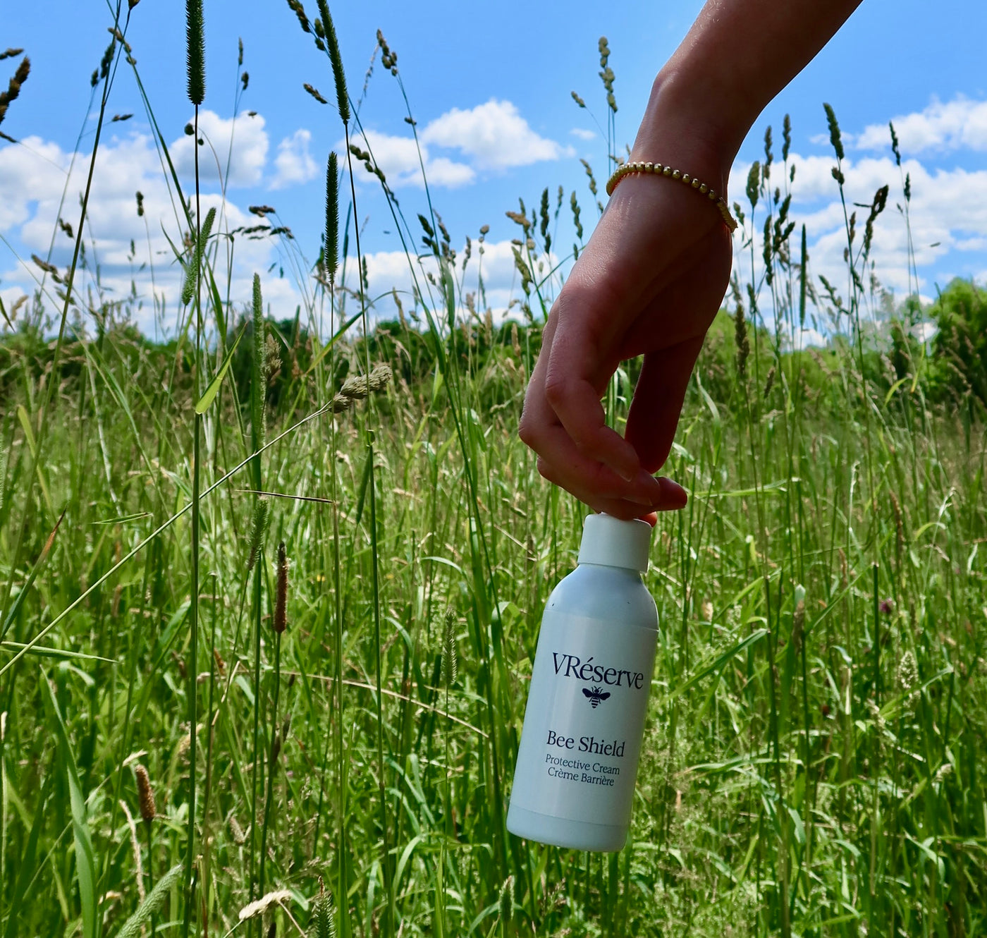 girl holding product in wheat field