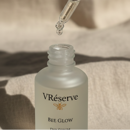 drop of clear serum coming out of dropper and back into the bee glow serum bottle