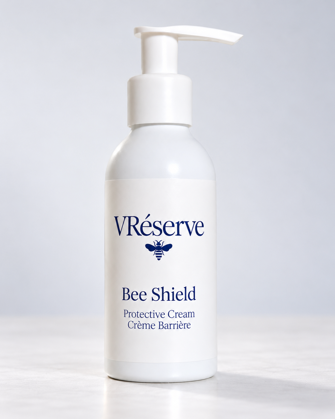 A white pump bottle of VRéserve Bee Shield Protective Cream with a white label and blue text, set against a clean light gray background.